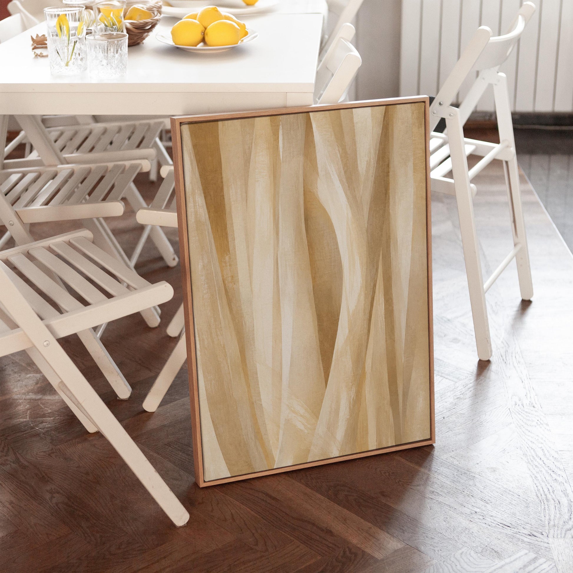 Golden beige ribbon strands flowing diagonally, canvas print shown in a sunlit, contemporary room