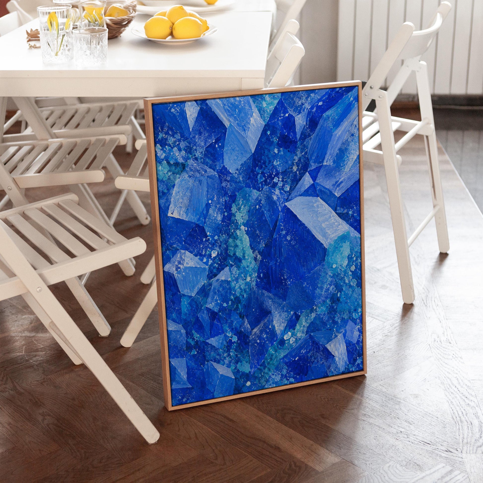 Faceted sapphire crystal planes with turquoise sparks, canvas print styled against a soft white wall