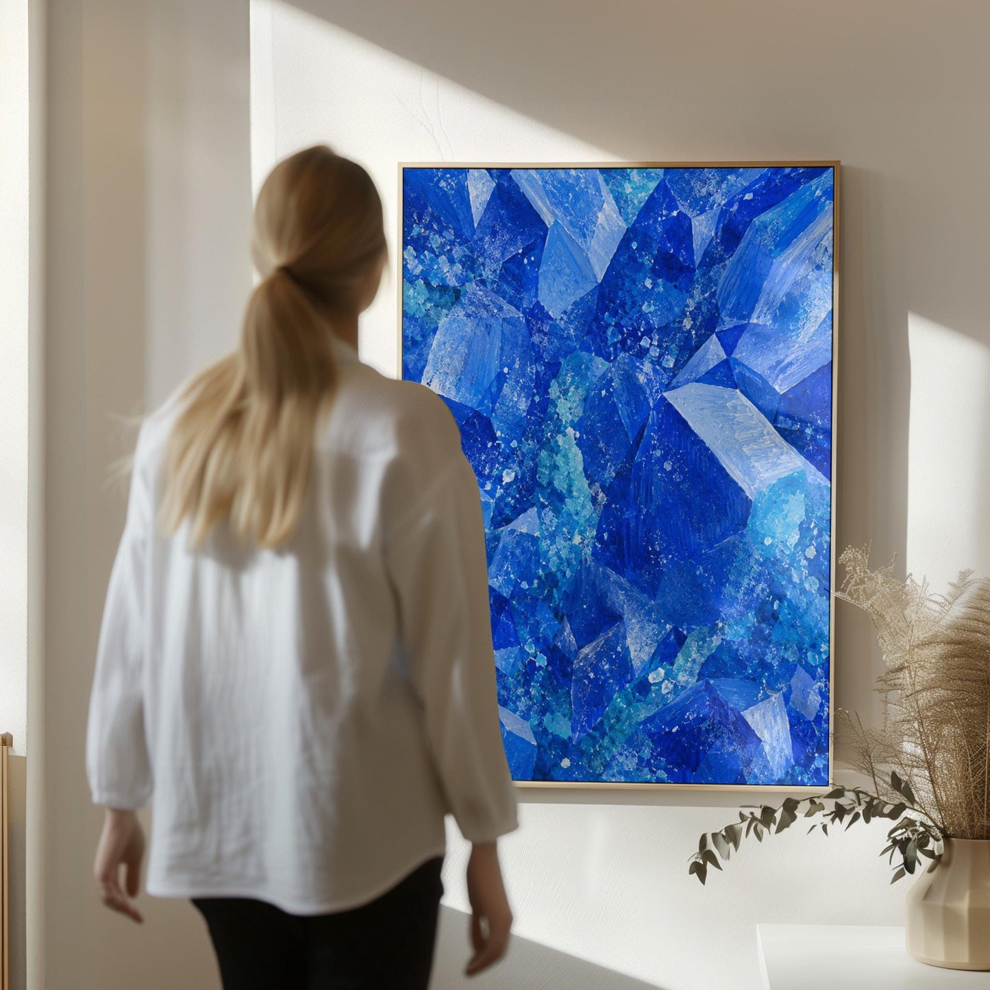 Faceted sapphire crystal planes with turquoise sparks, canvas wall art hanging in a calm, modern living space