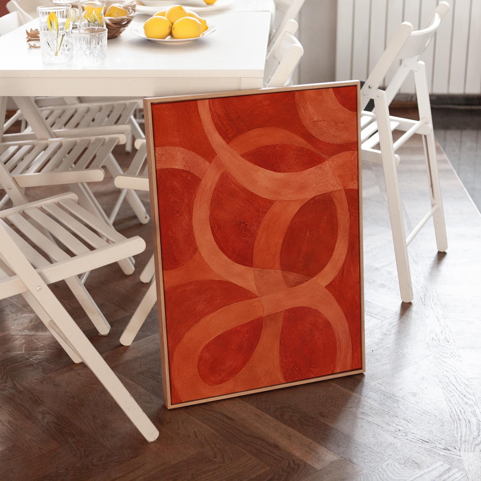 Interlocking loop rings in burnt orange and rust, canvas print shown in a sunlit, contemporary room