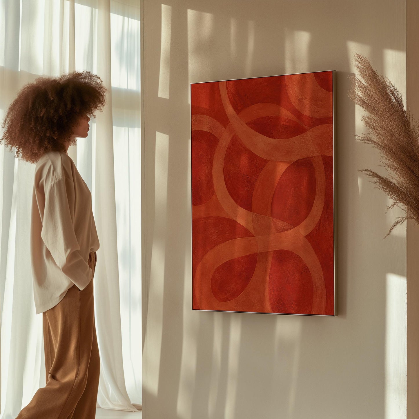 Interlocking loop rings in burnt orange and rust, canvas wall art hanging in a calm, modern living space
