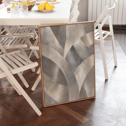 Crossing curved silver bands in graceful motion, canvas print presented in a light, minimal room