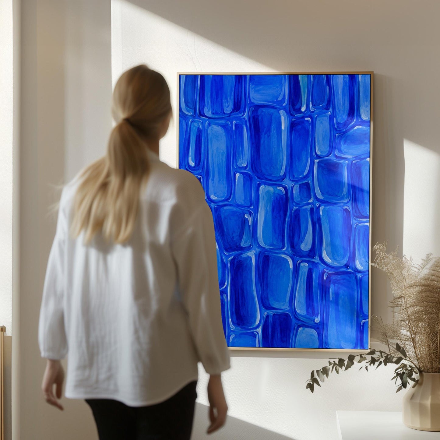 Bold cobalt brush stroke blocks in painterly rows, canvas print displayed on a neutral wall in a styled interior