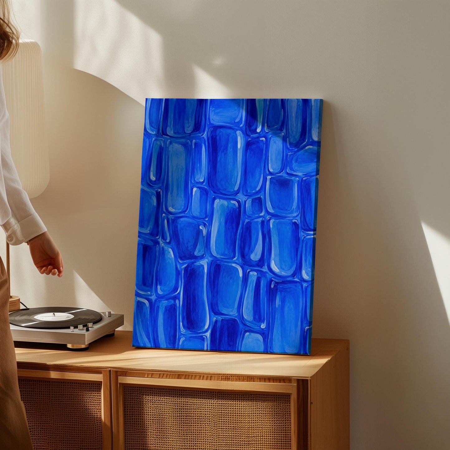 Bold cobalt brush stroke blocks in painterly rows, canvas wall art on a quiet wall in a considered interior
