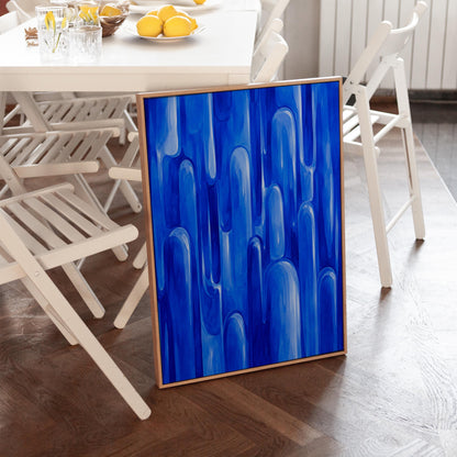 Vertical cobalt streaks like flowing rain, canvas print shown in a sunlit, contemporary room