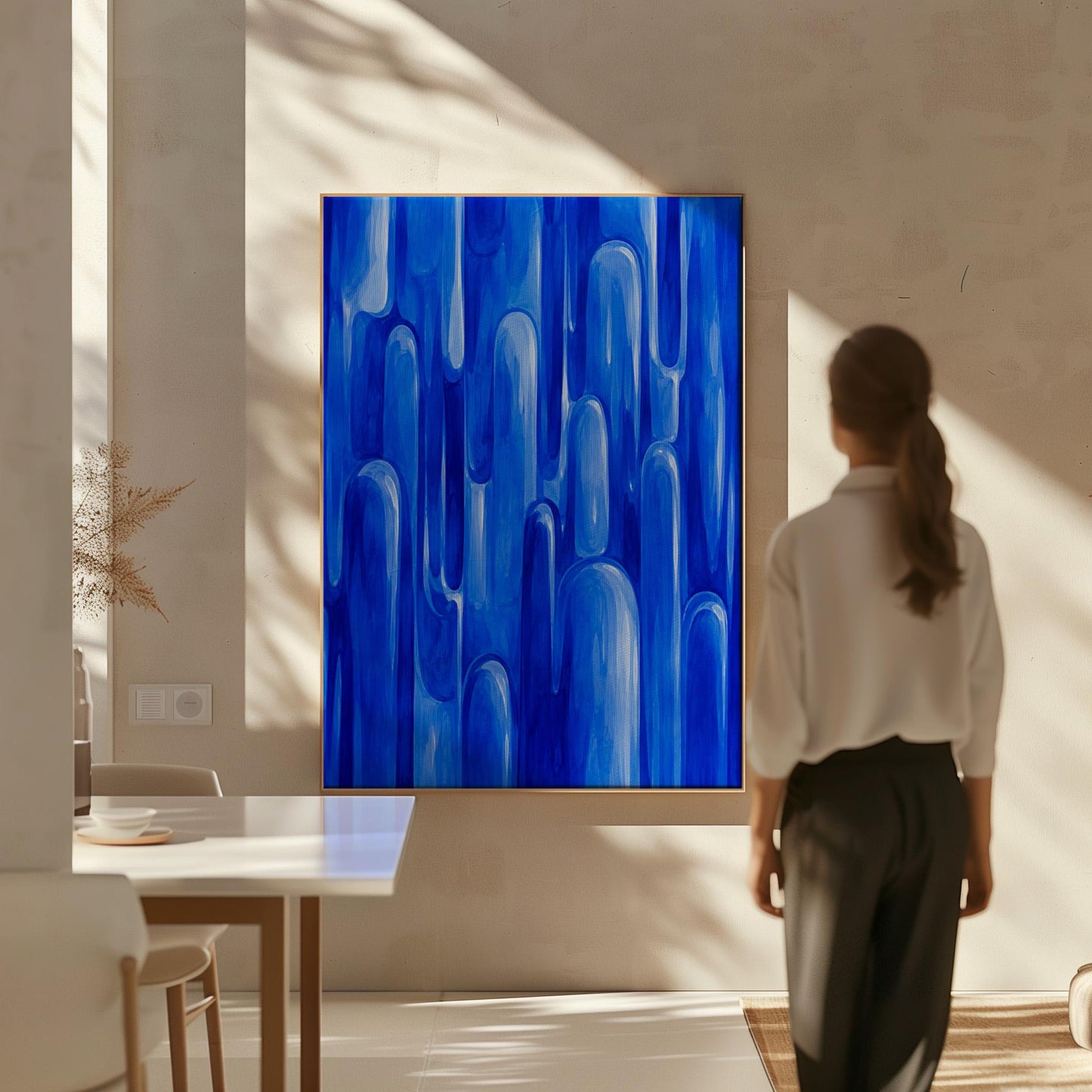 Vertical cobalt streaks like flowing rain, canvas wall art on a quiet wall in a considered interior