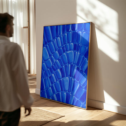 Fan arcs of cobalt mosaic pebbles, canvas print displayed on a neutral wall in a styled interior