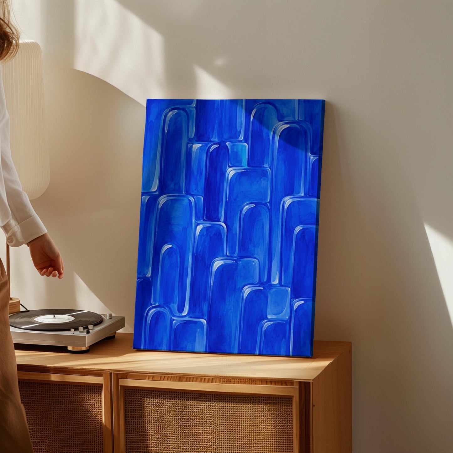 Rounded arch tile shapes in vivid cobalt blue, canvas wall art styled against a soft white wall