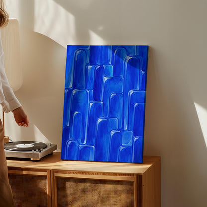 Rounded arch tile shapes in vivid cobalt blue, canvas wall art styled against a soft white wall