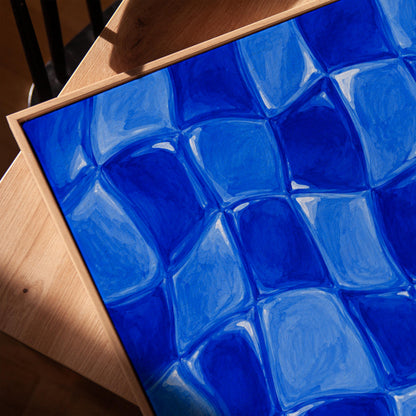 Wavy checkered squares in deep cobalt blue, canvas print in a warm, minimally styled interior
