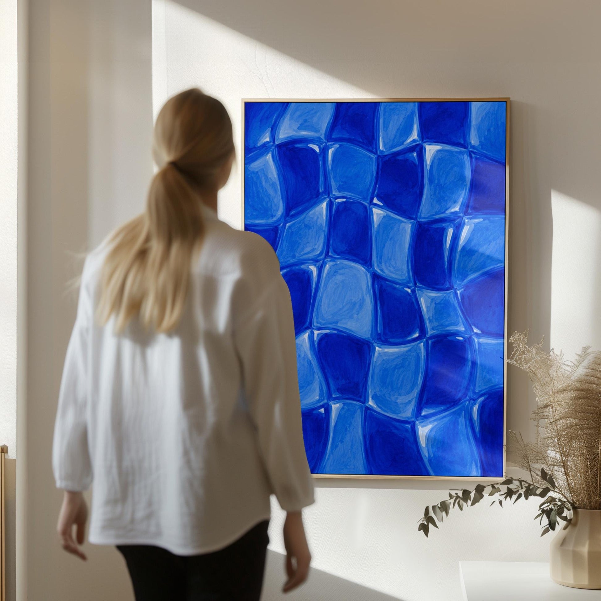 Wavy checkered squares in deep cobalt blue, canvas wall art hanging in a calm, modern living space