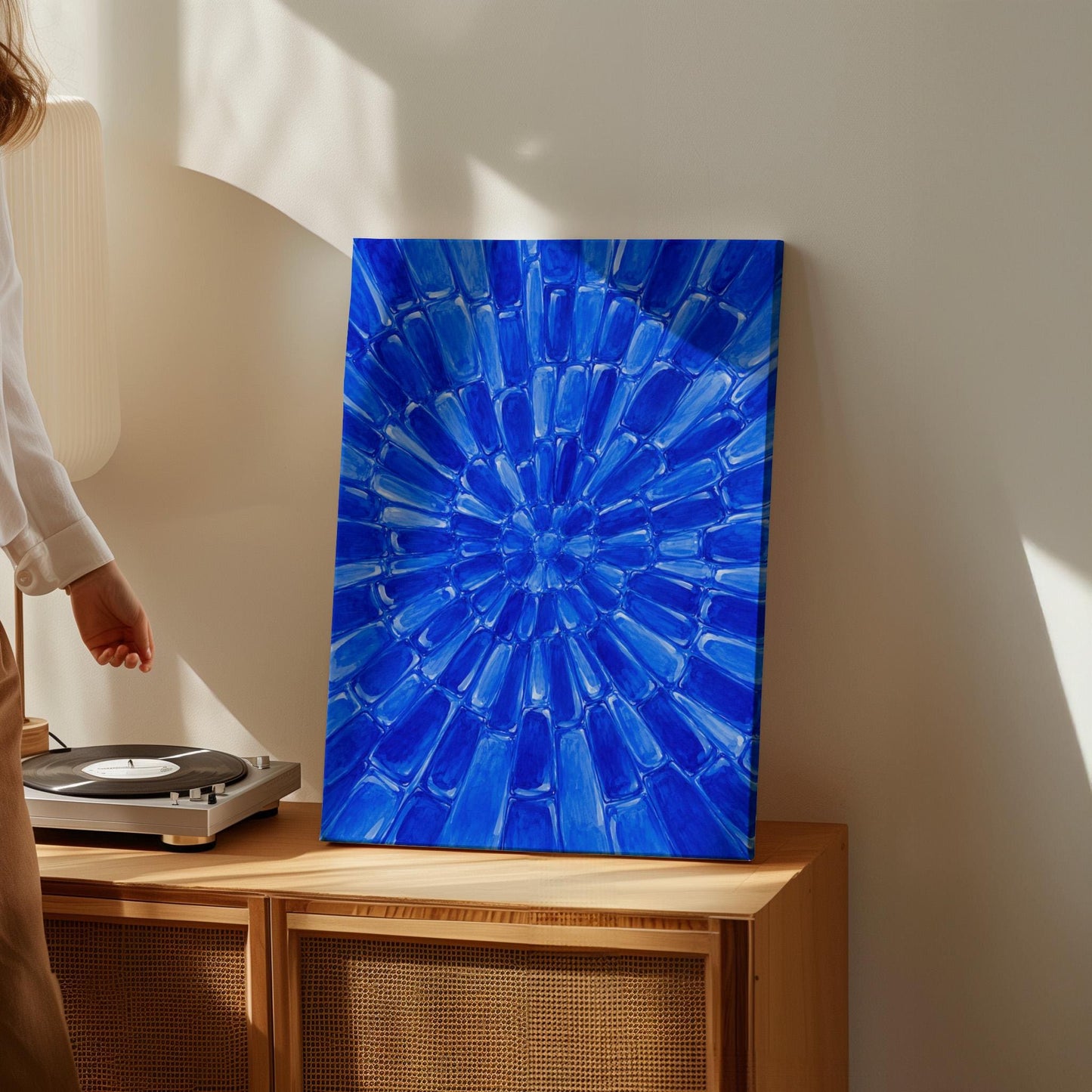 Radial starburst rays in electric cobalt blue, canvas print seen in a warm interior with natural light