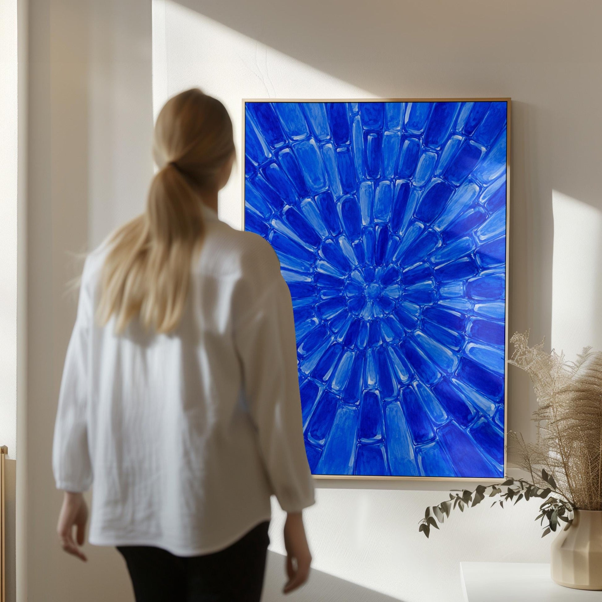 Radial starburst rays in electric cobalt blue, canvas print shown to scale in a furnished room