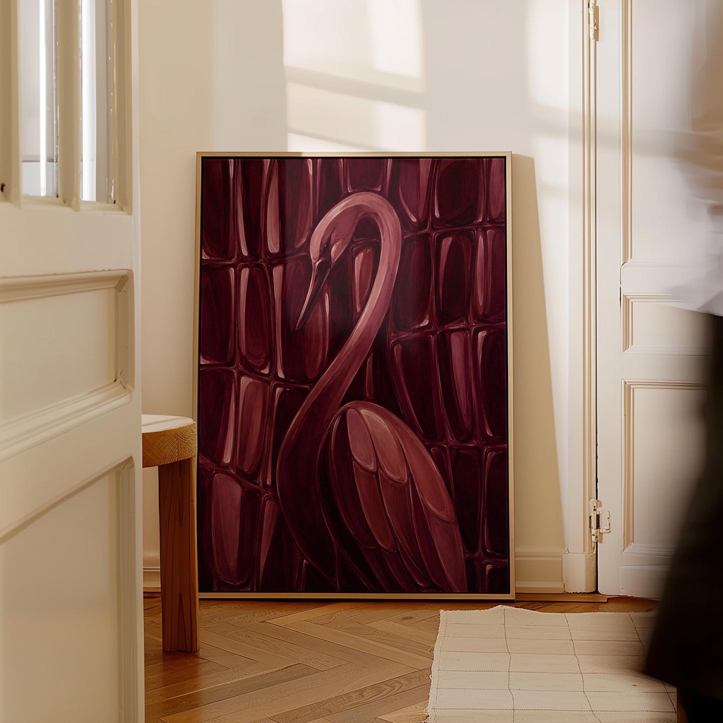 Flamingo silhouette emerging from deep burgundy, canvas print presented in a light, minimal room