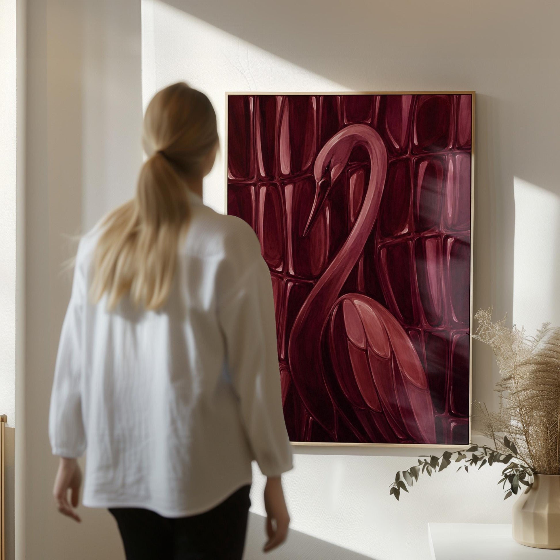 Flamingo silhouette emerging from deep burgundy, canvas print shown to scale in a furnished room