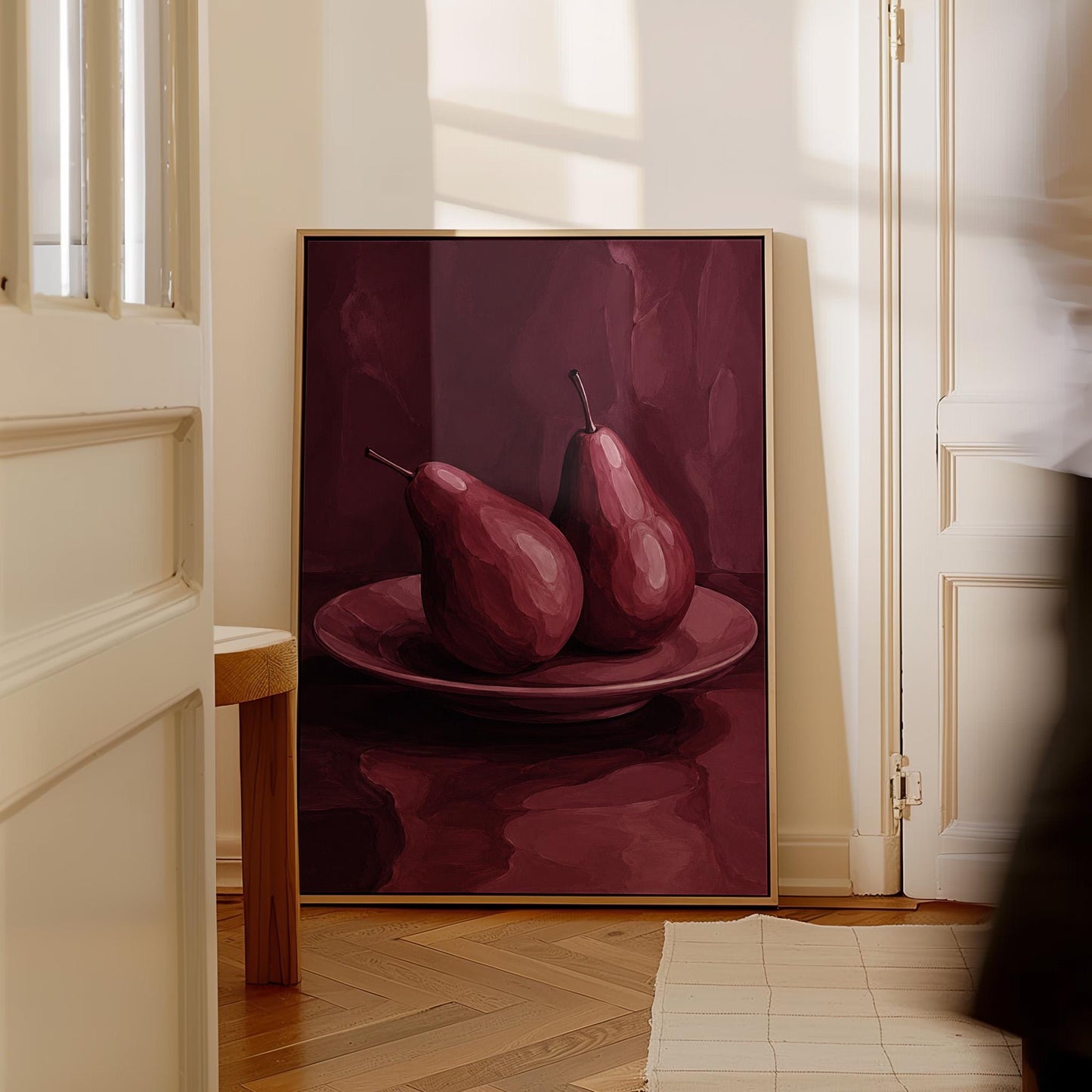 Two pears on a plate painted in burgundy monochrome, canvas print shown in a sunlit, contemporary room