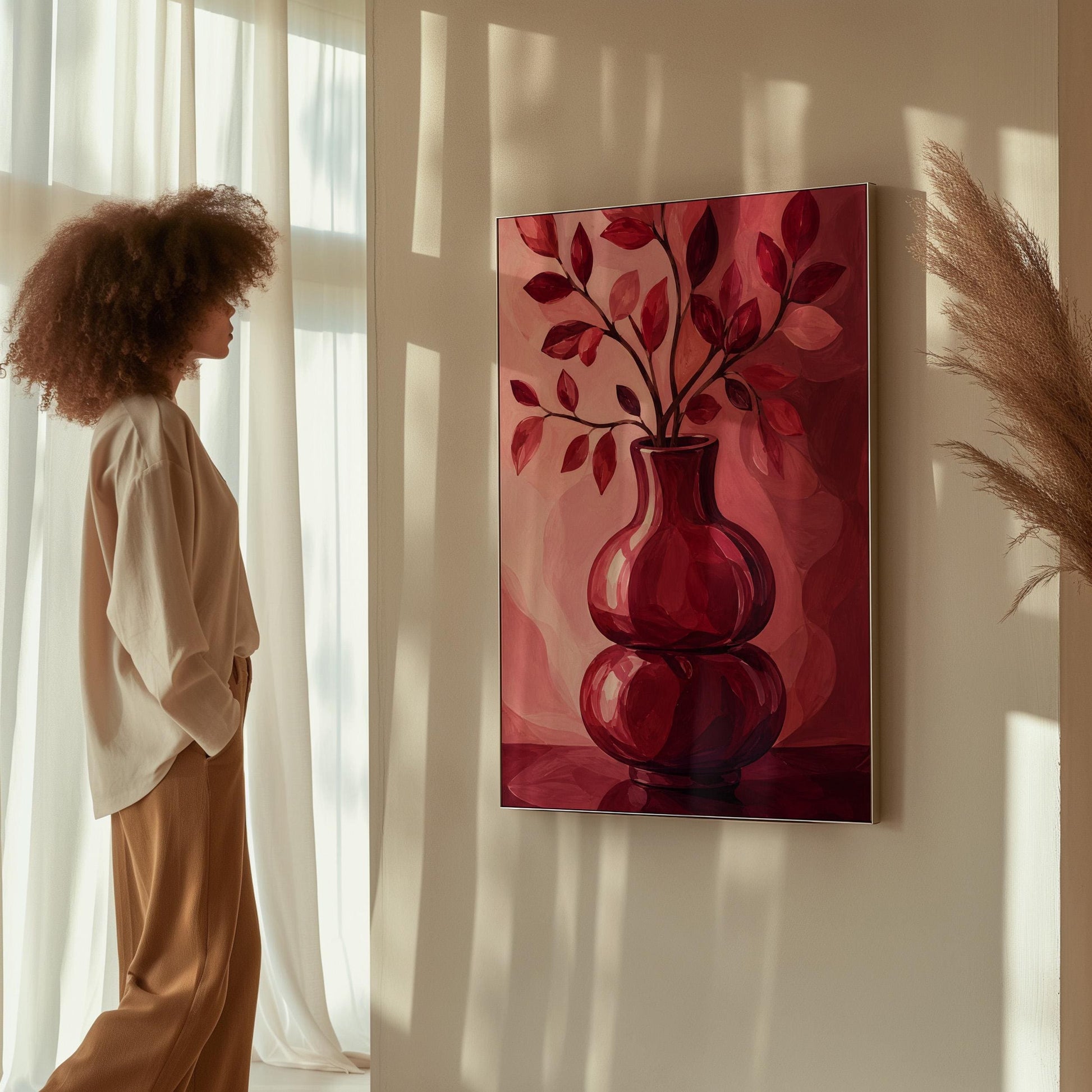 Curvy red vase with leafy branch in burgundy tones, canvas print seen in a warm interior with natural light