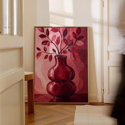 Curvy red vase with leafy branch in burgundy tones, canvas wall art seen in a warm interior with natural light