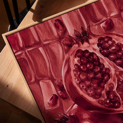 Open pomegranate with ruby seeds in burgundy tones, canvas print in a warm, minimally styled interior