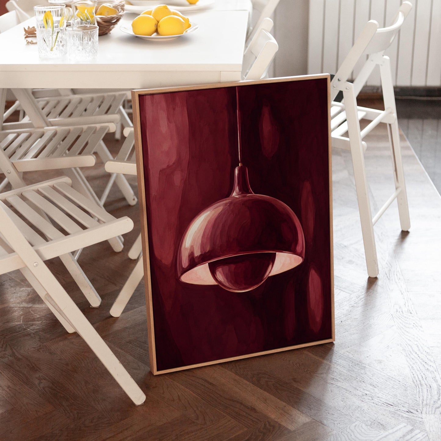 Pendant lamp glowing warmly against burgundy darkness, canvas print on a quiet wall in a considered interior
