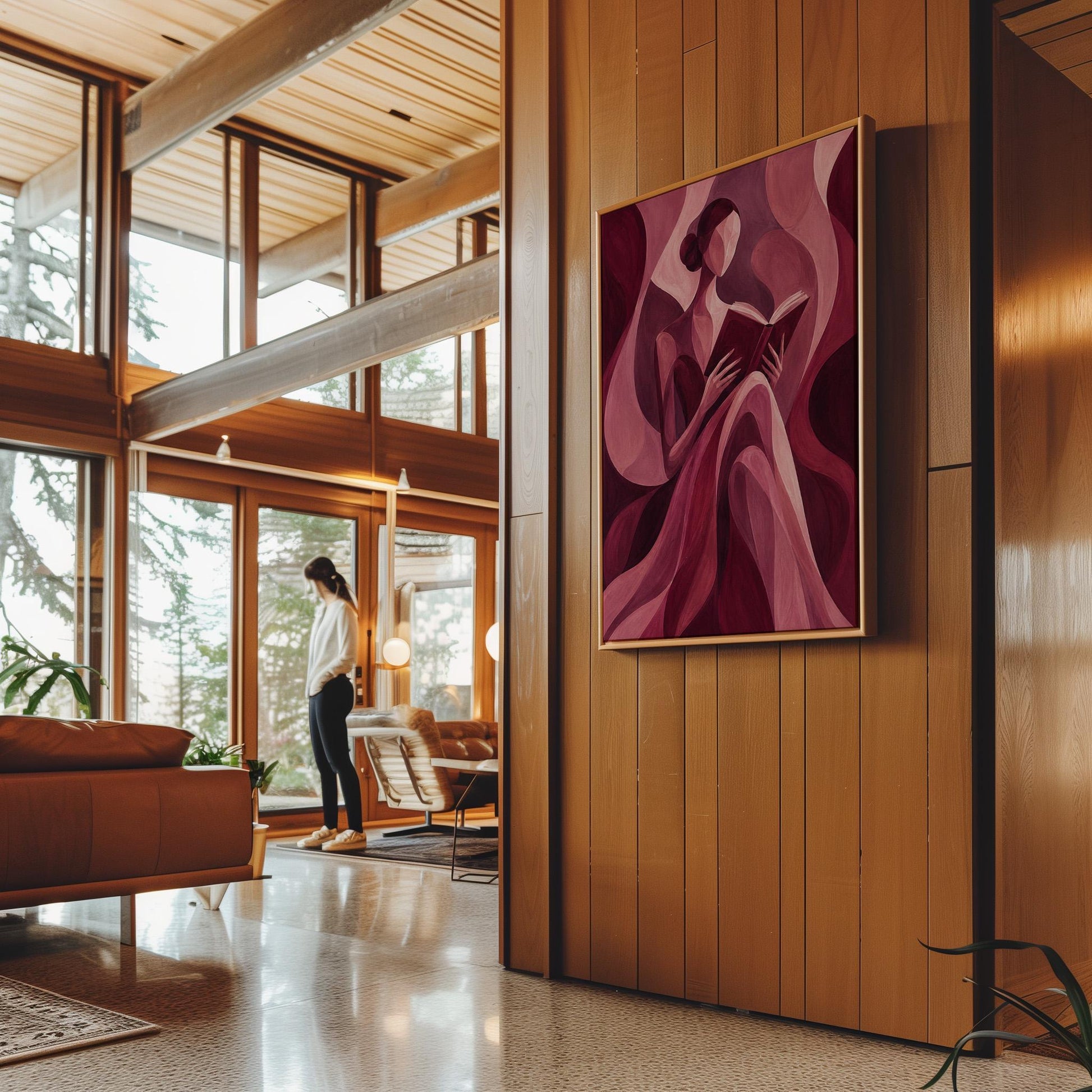 Woman reading a book among flowing burgundy drapes, canvas print hanging in a calm, modern living space