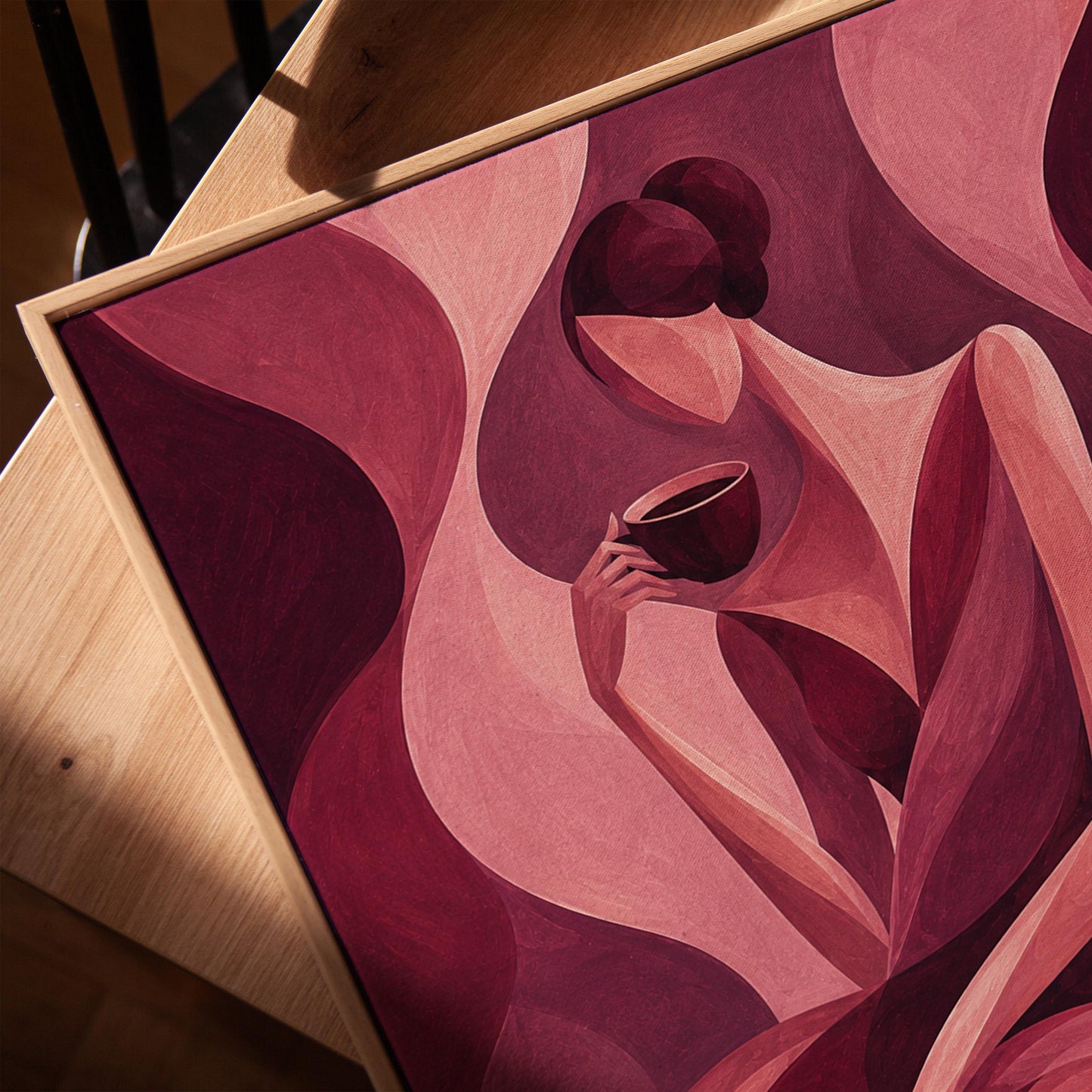 Woman sipping coffee among soft burgundy waves, canvas print in a warm, minimally styled interior