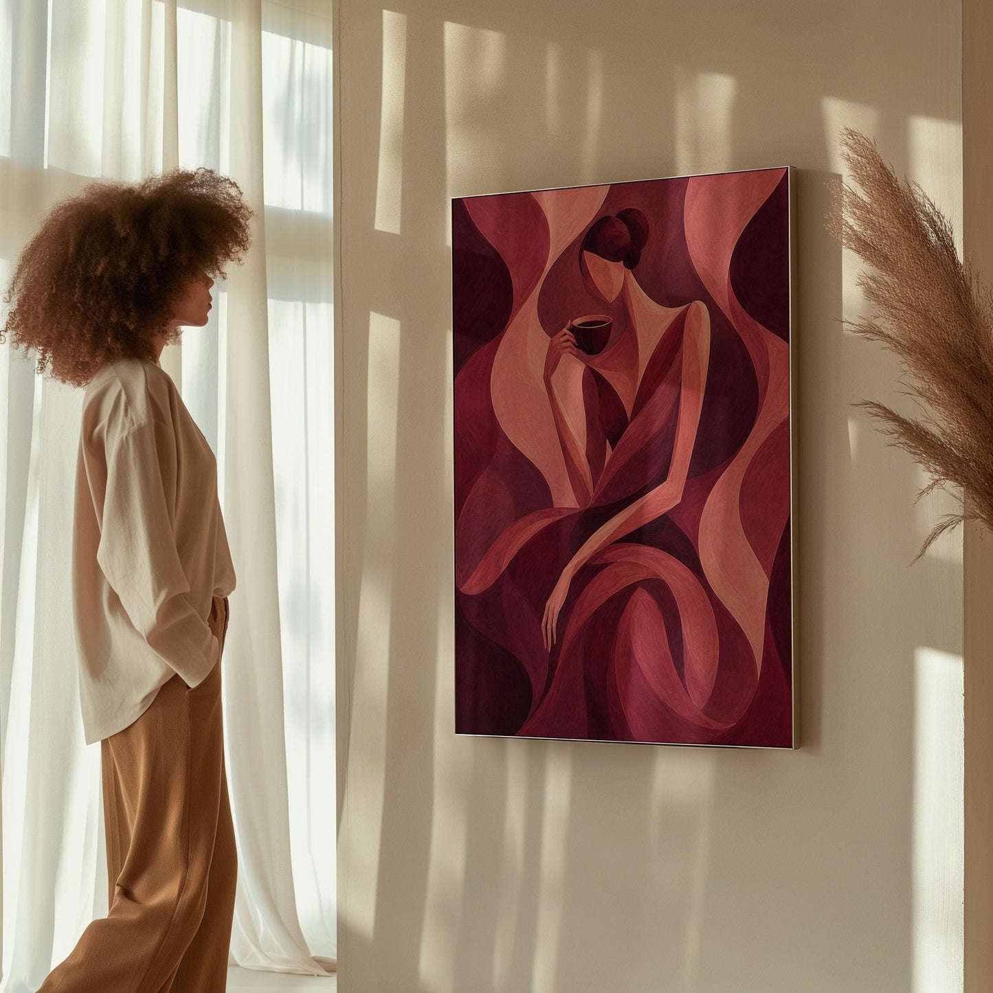 Woman sipping coffee among soft burgundy waves, canvas print shown in a sunlit, contemporary room