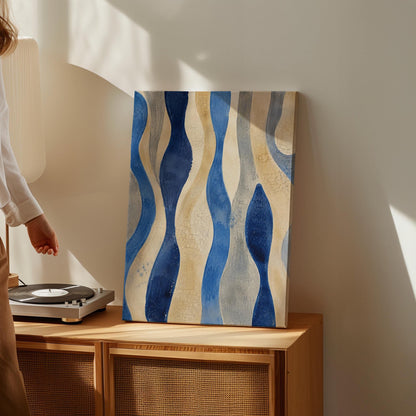 Vertical flowing wave bands in indigo and cream, canvas print presented in a light, minimal room