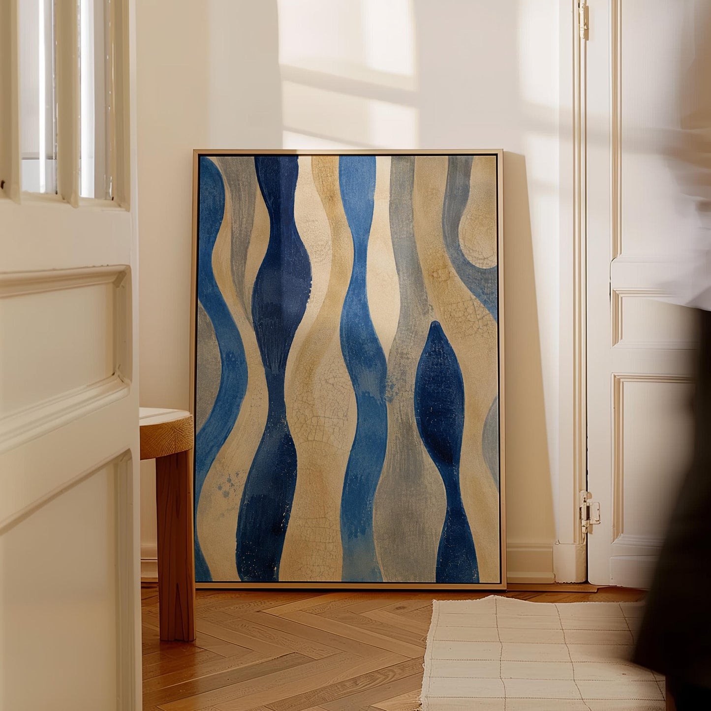 Vertical flowing wave bands in indigo and cream, canvas wall art on a quiet wall in a considered interior