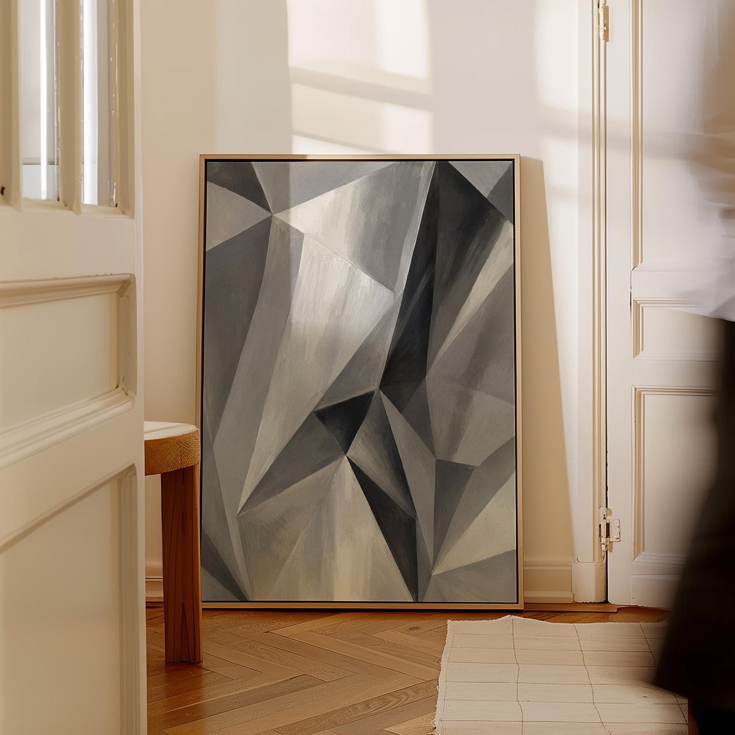 Angular graphite planes with sharp light play, canvas print styled against a soft white wall