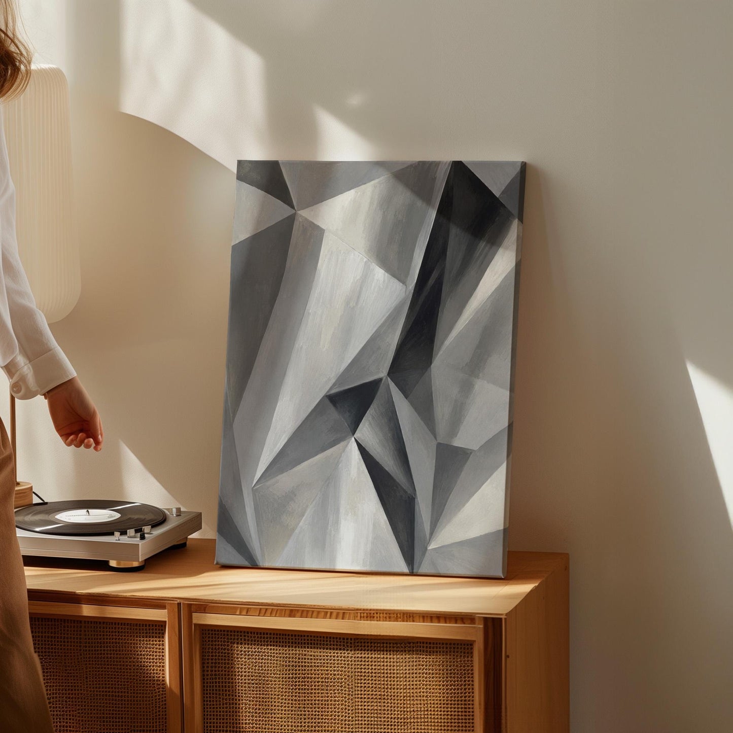 Angular graphite planes with sharp light play, canvas wall art presented in a light, minimal room