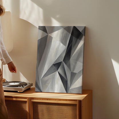 Angular graphite planes with sharp light play, canvas wall art presented in a light, minimal room