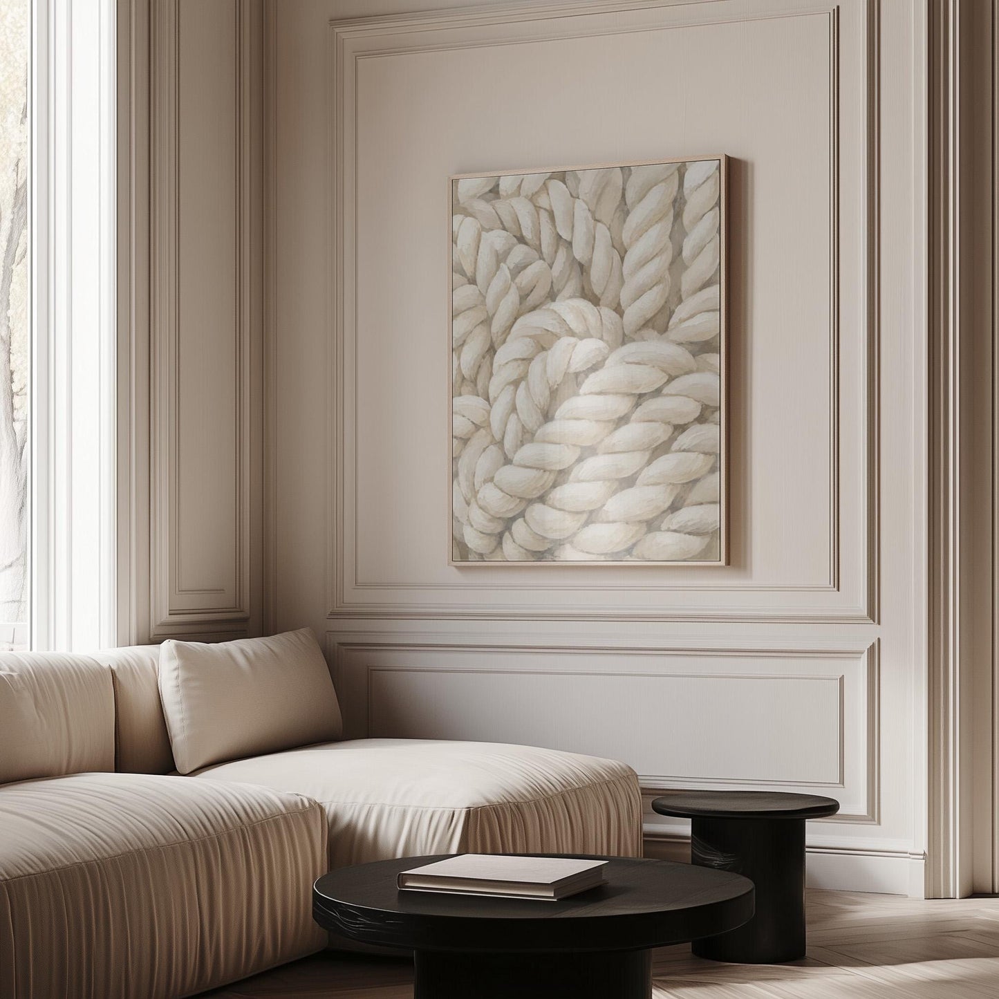 Thick cream ropes twisted into a knot, canvas wall art hanging in a calm, modern living space