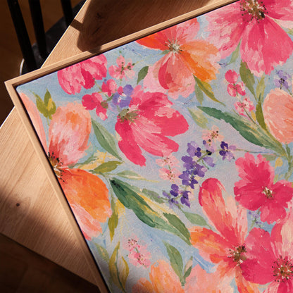 Vivid pink and purple watercolor blooms on light blue, canvas print in a warm, minimally styled interior