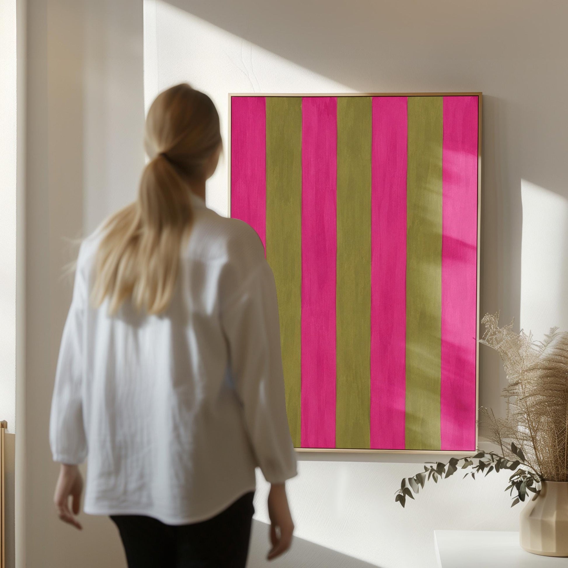Bold vertical stripes in hot pink and olive green, canvas print shown in a sunlit, contemporary room