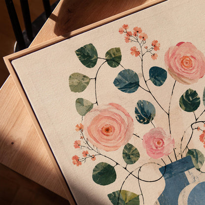 Roses and sprigs in two blue collage vases, canvas print in a warm, minimally styled interior