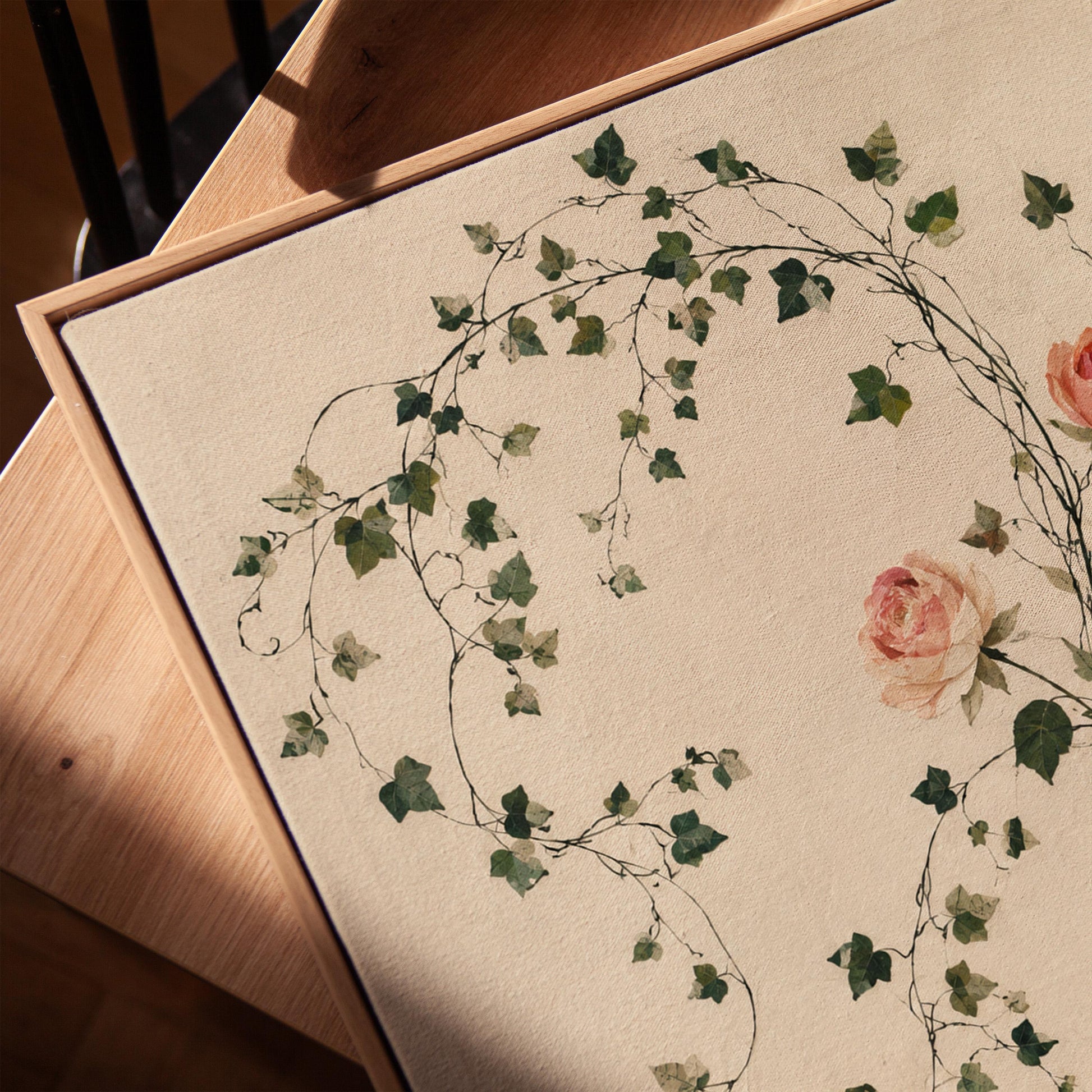 Ivy vines and single rose trailing from bottle vase, canvas print in a warm, minimally styled interior
