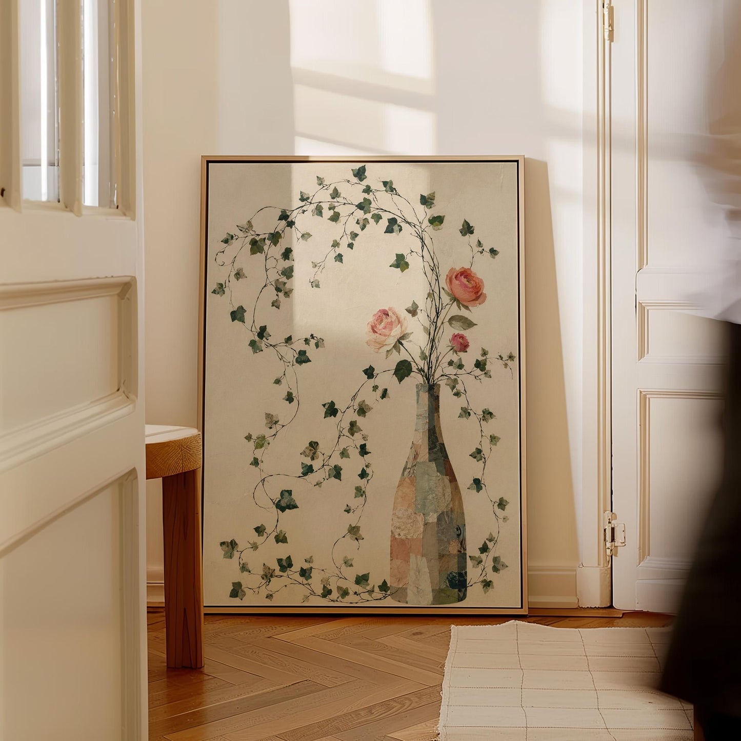 Ivy vines and single rose trailing from bottle vase, canvas print hanging in a calm, modern living space