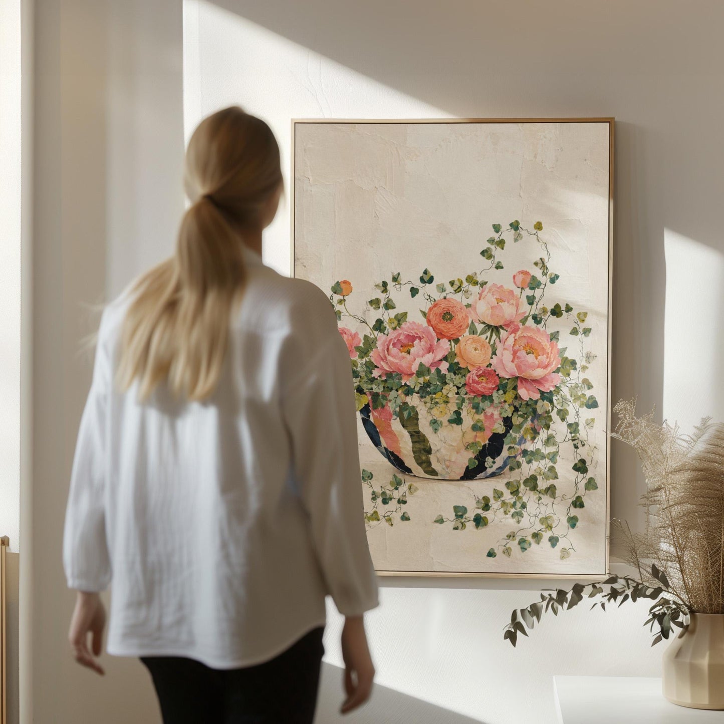 Blush peonies in bowl with cascading ivy, canvas print seen in a warm interior with natural light