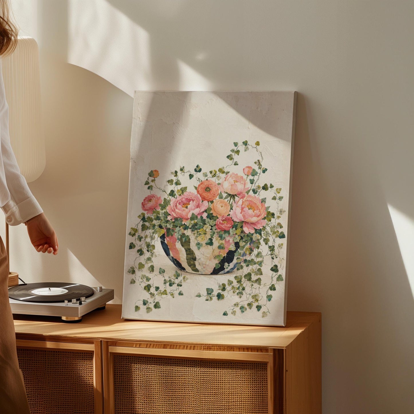 Blush peonies in bowl with cascading ivy, canvas print on a quiet wall in a considered interior
