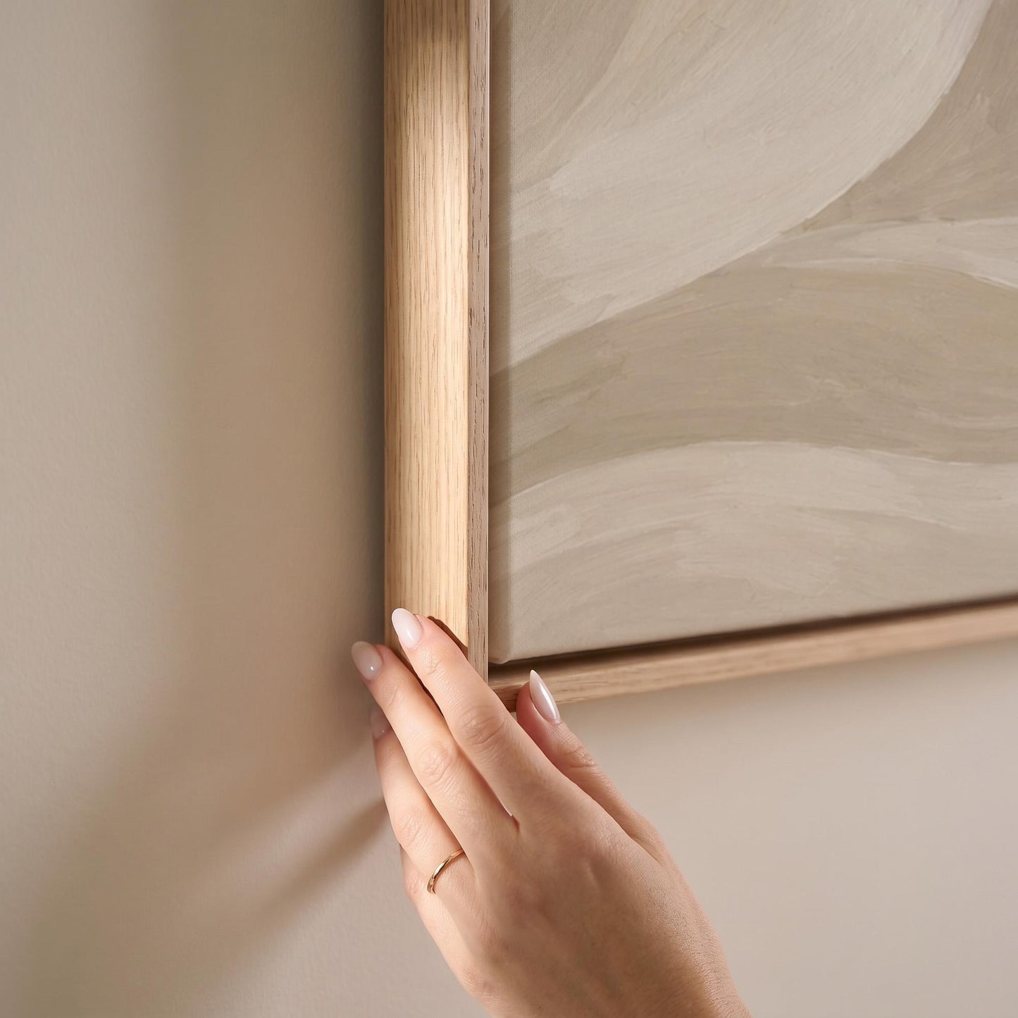 Soft sand waves flowing across horizontal canvas, canvas print shown at full size in a light-filled bedroom