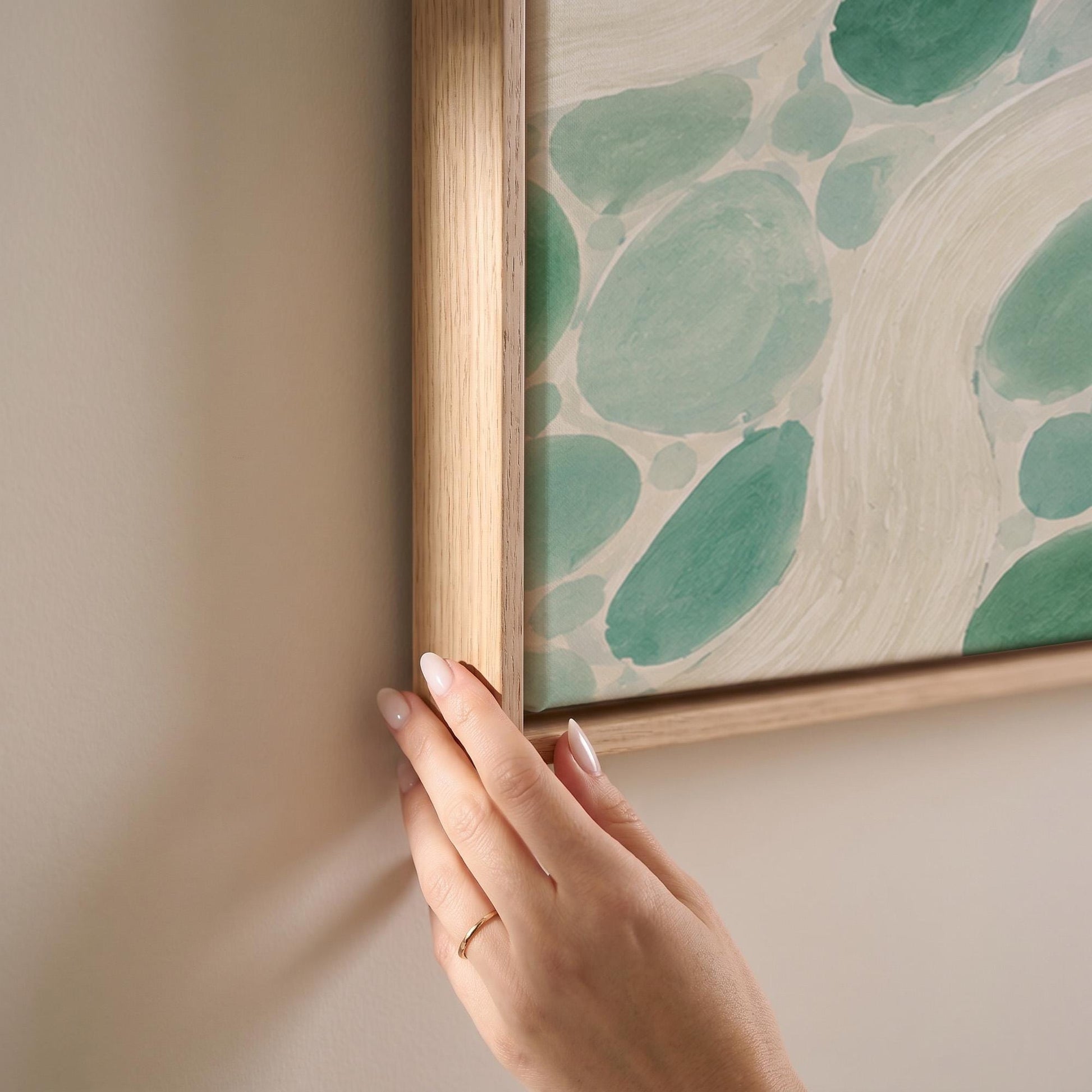 Aqua pebbles flowing like a stream horizontally, canvas print shown at full size in a light-filled bedroom