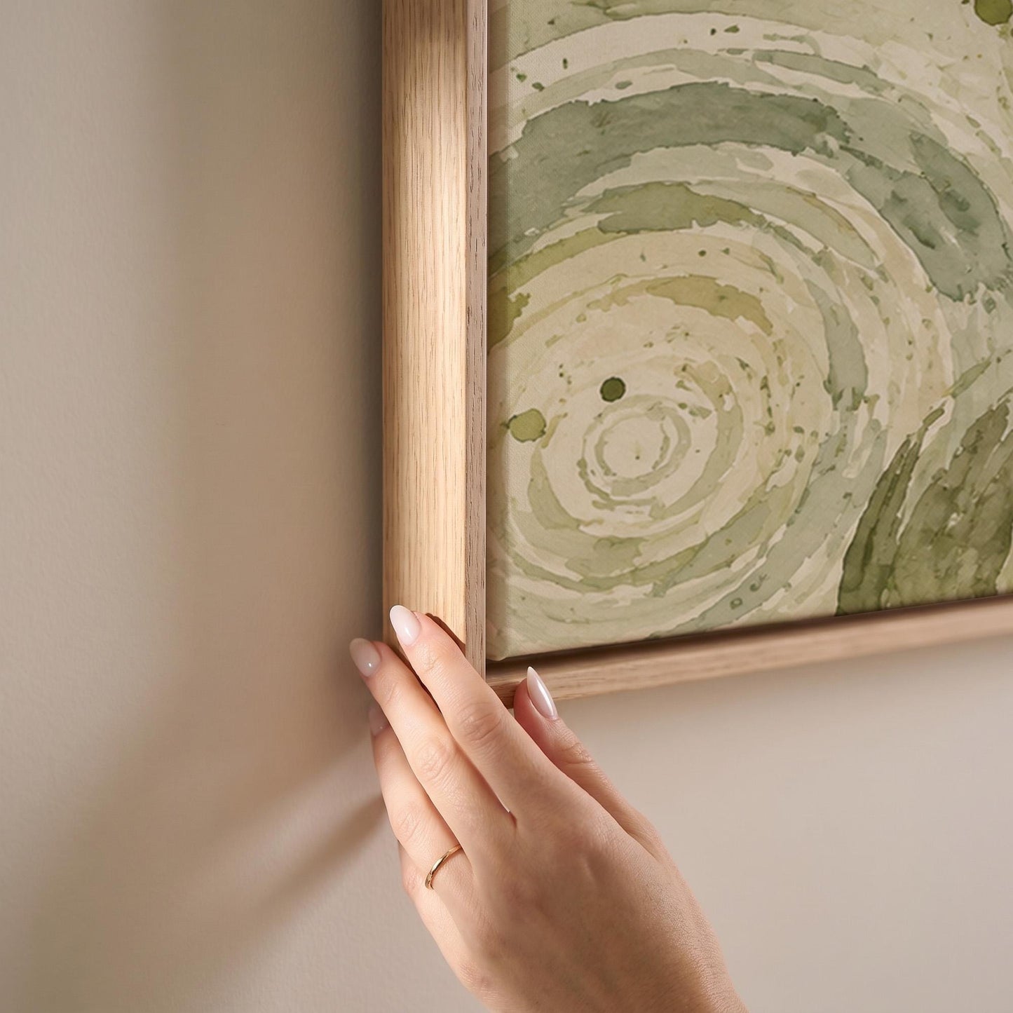 Swirling sage green ring circles, canvas print shown at full size in a light-filled bedroom