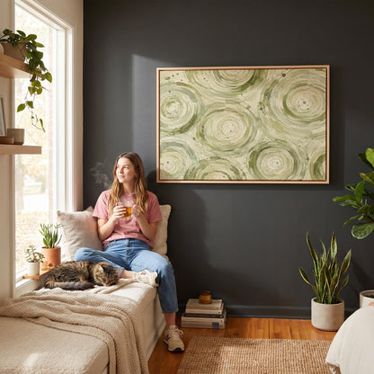 Swirling sage green ring circles, canvas print presented in a light, minimal room