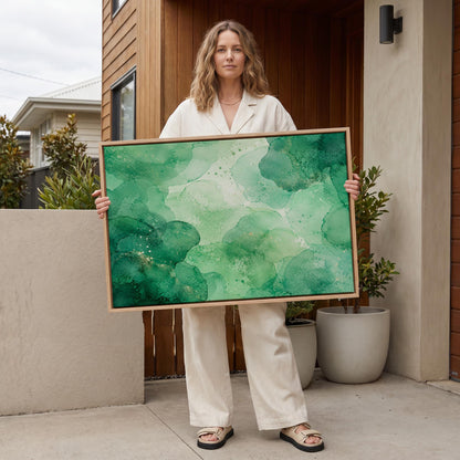 Wide emerald green watercolor wash, canvas print displayed on a neutral wall in a styled interior