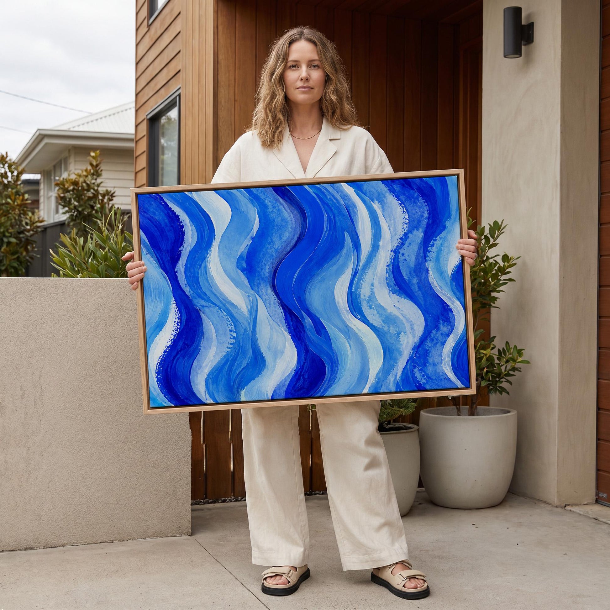 Bold cobalt wave currents across wide canvas, canvas print shown in a sunlit, contemporary room