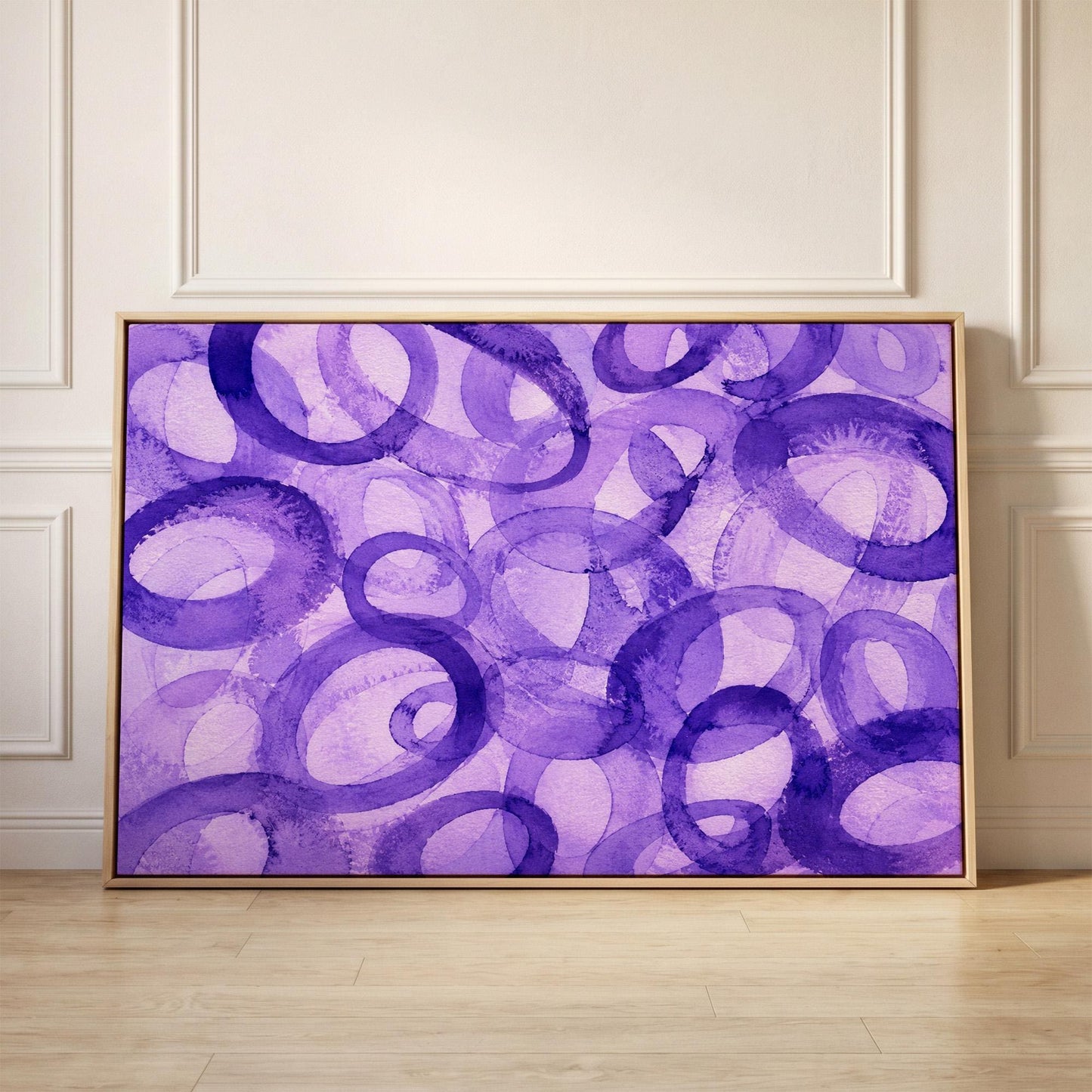 Swirling violet watercolor rings across wide frame, canvas print held up against a sunlit bedroom wall