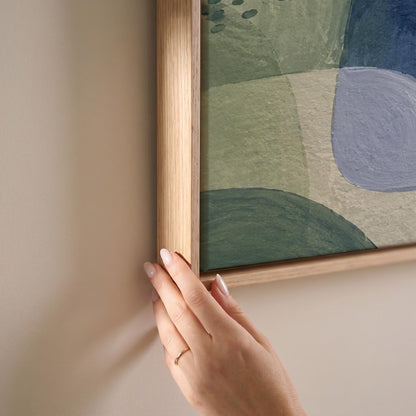 Soft muted shapes in dusty plum and sage, canvas print shown at full size in a light-filled bedroom
