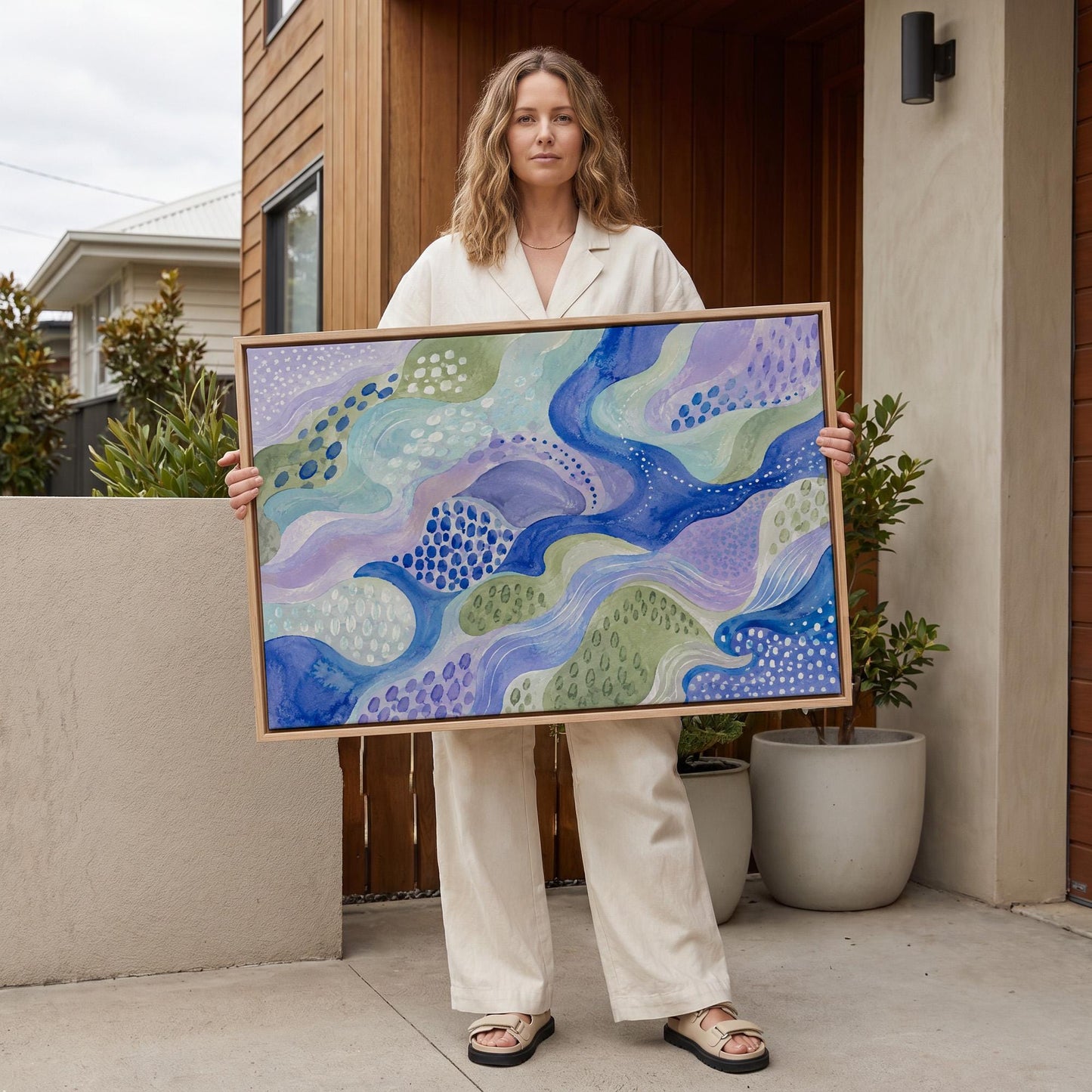 Meandering blue streams among dotted lavender islands, canvas wall art styled against a soft white wall