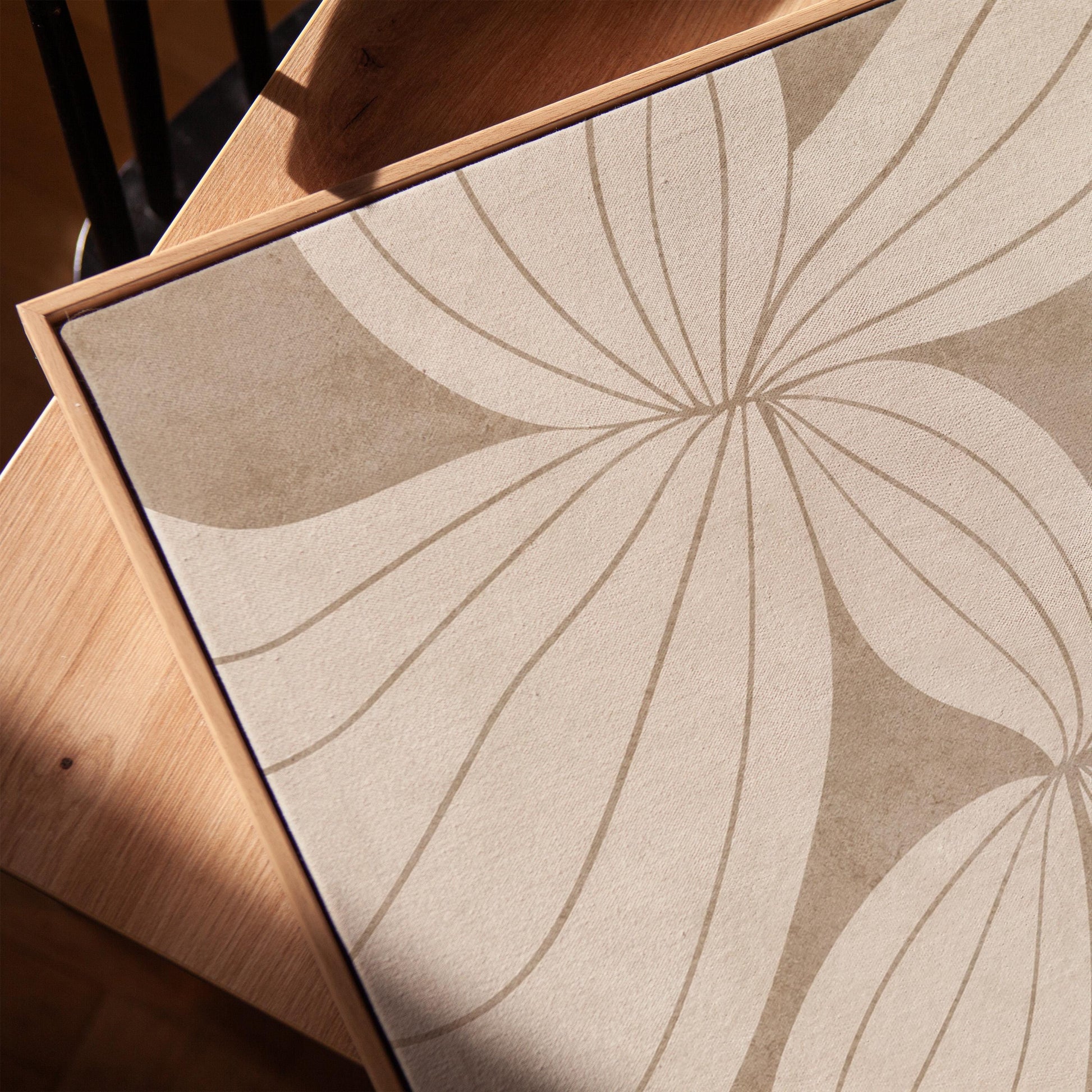 Abstract line drawing of oversized petals in cream and sand beige, canvas print in a warm, minimally styled interior